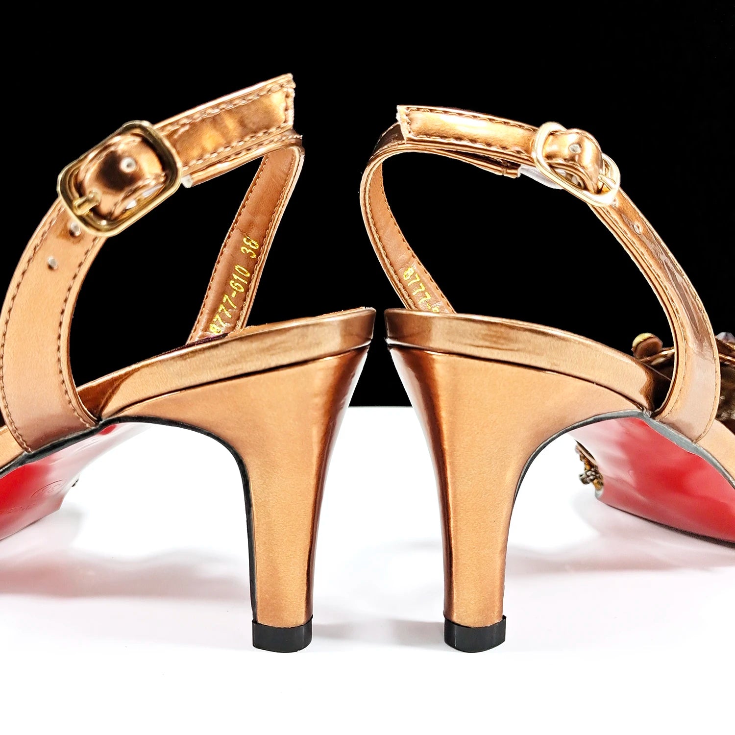 decorated-bronze-pointed-toe-heels-pair-closeup-back