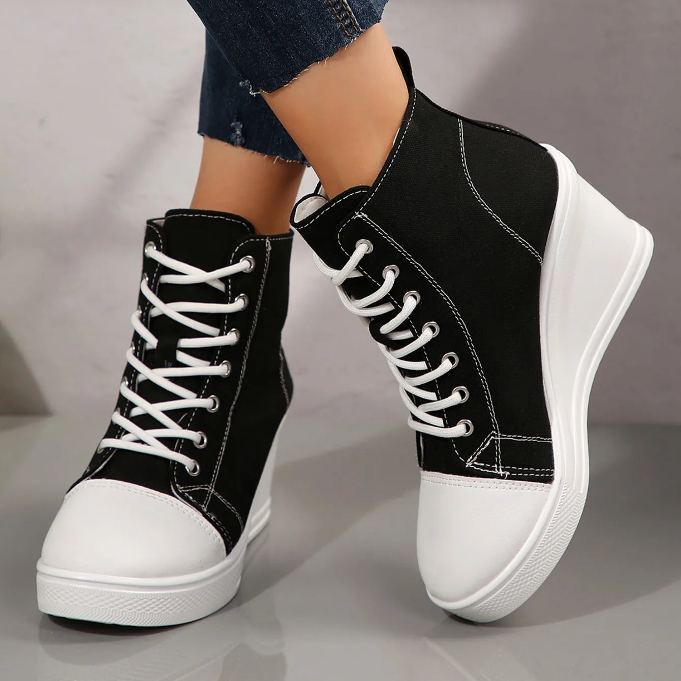 black-high-top-wedge-sneakers-crossed-legs