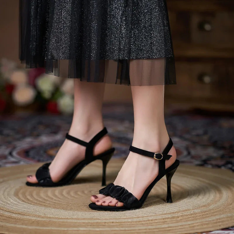 black-ruffle-heeled-sandals-woman-pair