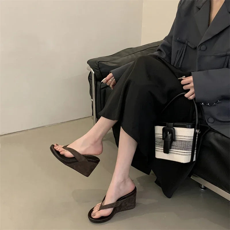 brown-flip-flop-wedges-pair-woman