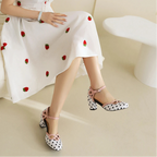 pink-black-white-polka-dot-block-heels-woman-sitting