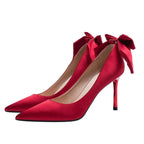 red-heels-with-bow-on-back
