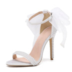 white-heels-with-bow-and-pearls