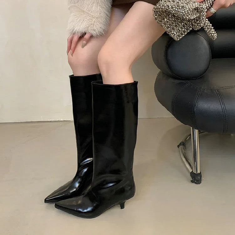 woman-sitting-wearing-black-kitten-heel-knee-high-boots