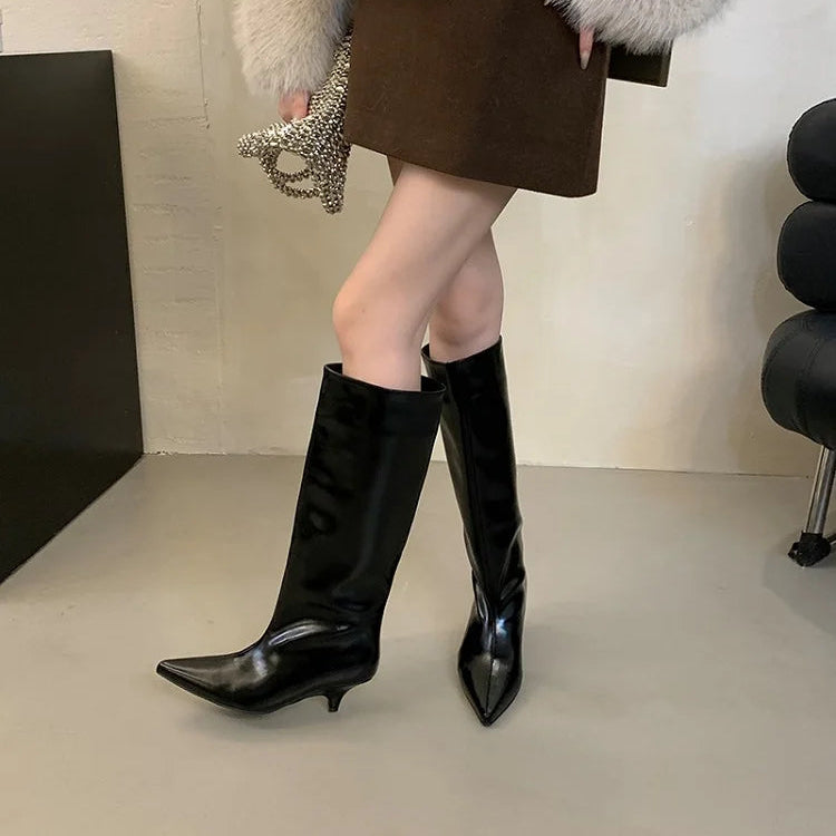 woman-wearing-black-kitten-heel-knee-high-boots