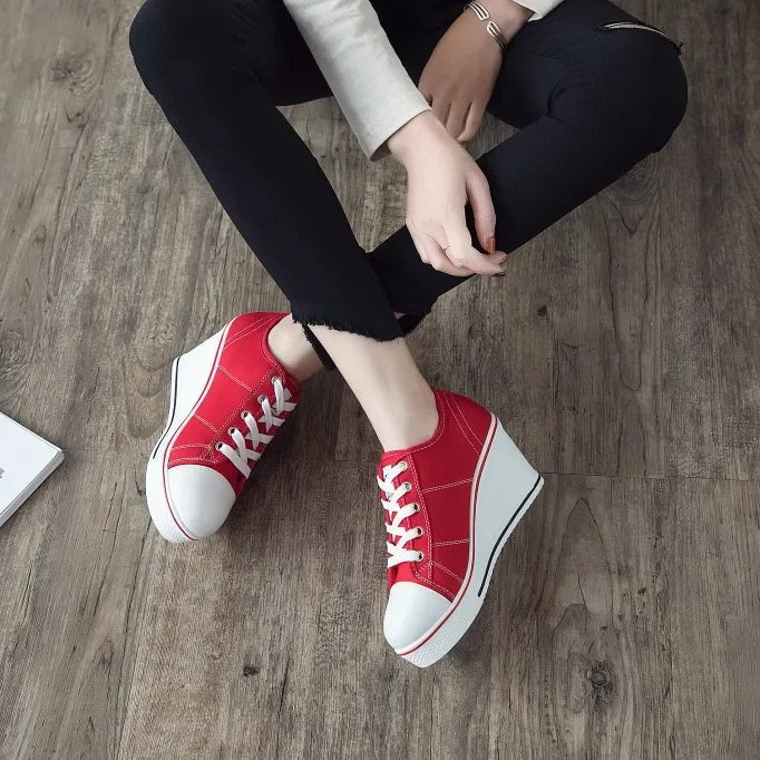 women-red-wedge-sneakers-sitting